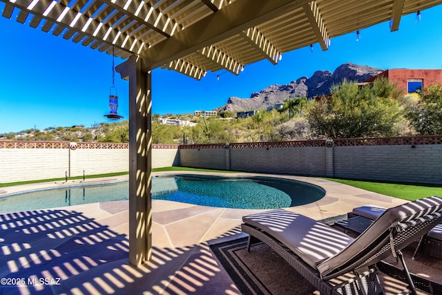 view of pool with a mountain view, a patio area, and a pergola