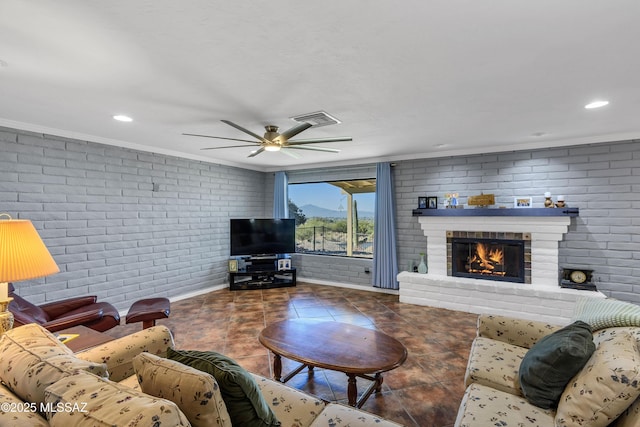 tiled living room featuring ornamental molding, brick wall, ceiling fan, and a brick fireplace