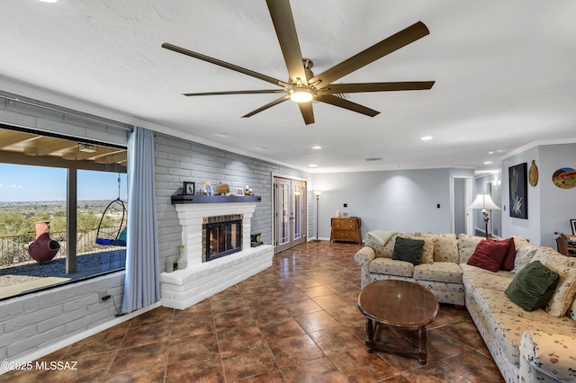 living room featuring crown molding, a fireplace, and ceiling fan