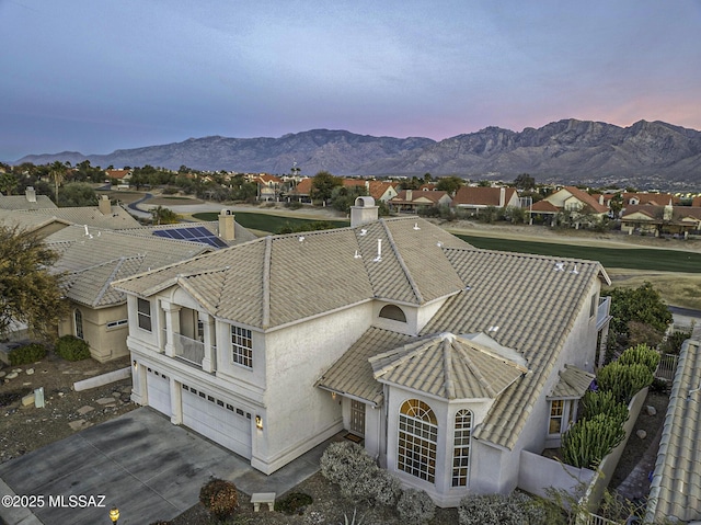 aerial view at dusk featuring a mountain view