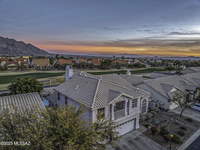 aerial view at dusk featuring a mountain view