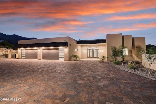 6138 N Jochums Dr, Tucson, AZ 85718 - view of front of property featuring a mountain view, french doors, and a garage