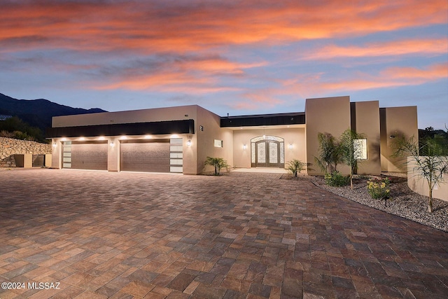 view of front of property featuring a mountain view, french doors, and a garage