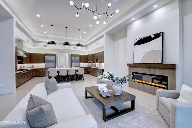 living room featuring a towering ceiling and a raised ceiling