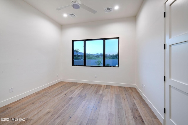 empty room featuring ceiling fan and light hardwood / wood-style flooring