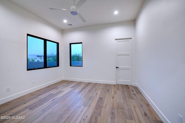 empty room with light hardwood / wood-style floors and ceiling fan