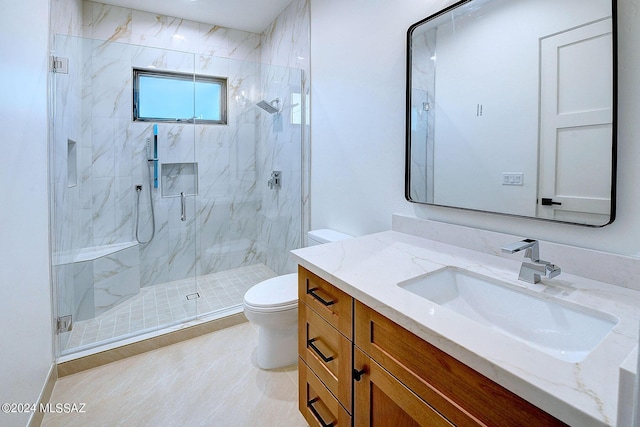 bathroom featuring toilet, an enclosed shower, and vanity