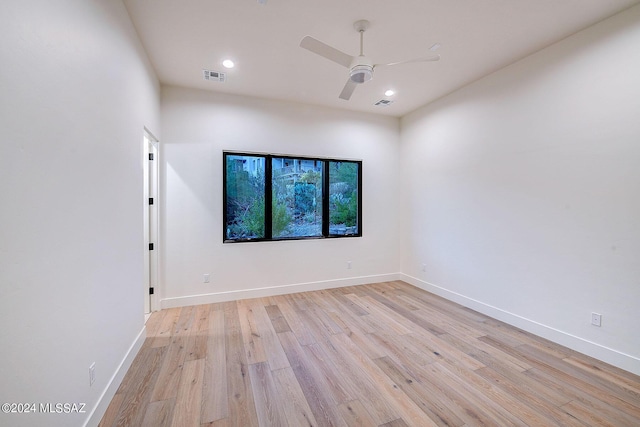 spare room with ceiling fan and light wood-type flooring