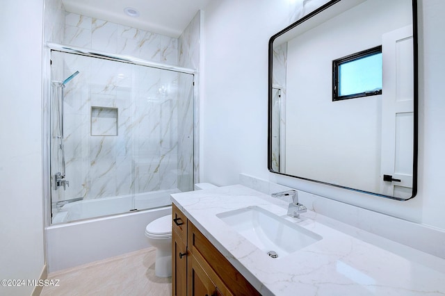 full bathroom with vanity, toilet, and bath / shower combo with glass door