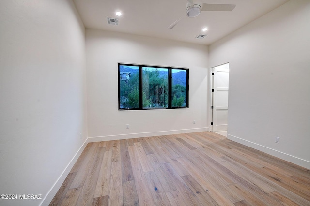 unfurnished room featuring light hardwood / wood-style floors and ceiling fan