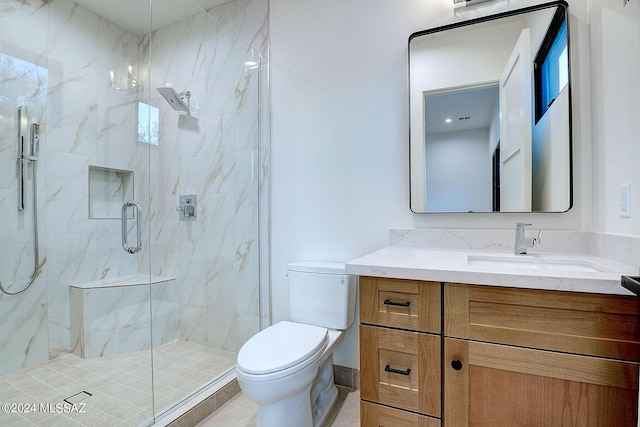 bathroom with vanity, toilet, and an enclosed shower