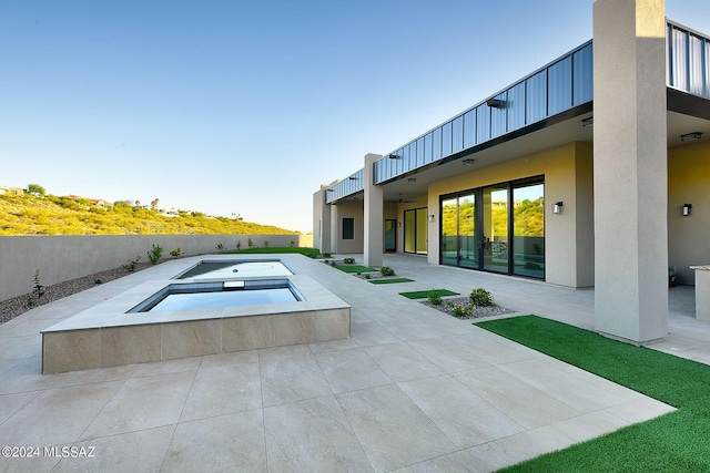 view of pool featuring an in ground hot tub and a patio area