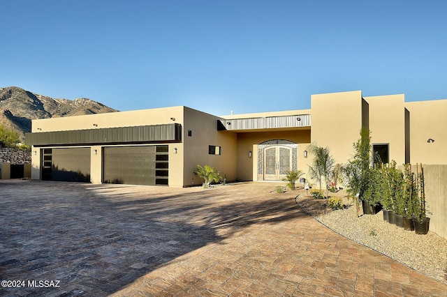 southwest-style home featuring a garage and a mountain view