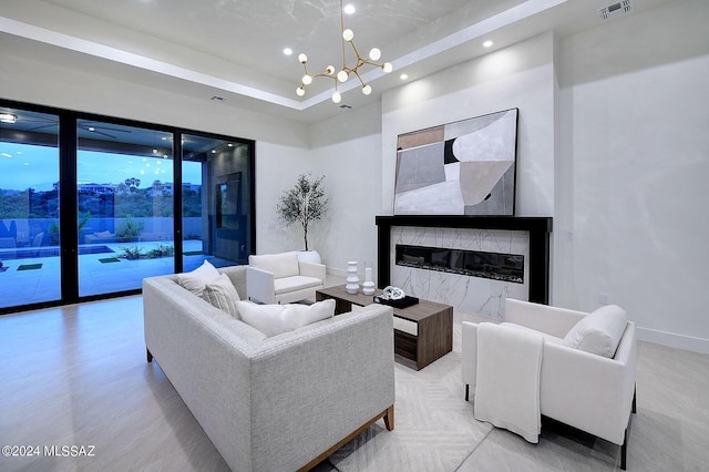 living room with an inviting chandelier and a fireplace