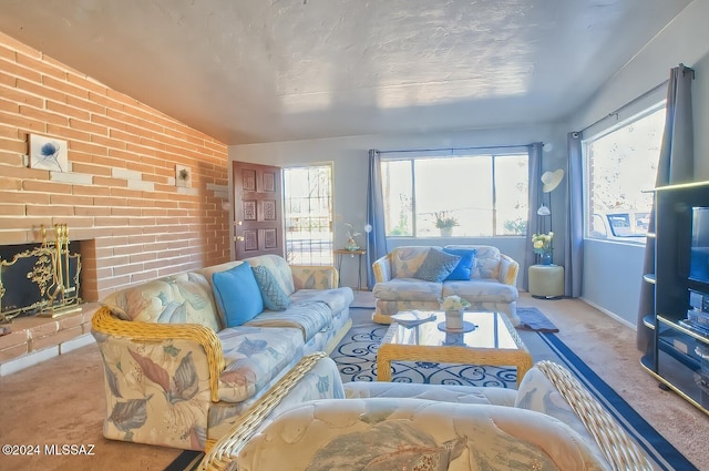 carpeted living room featuring a fireplace and vaulted ceiling