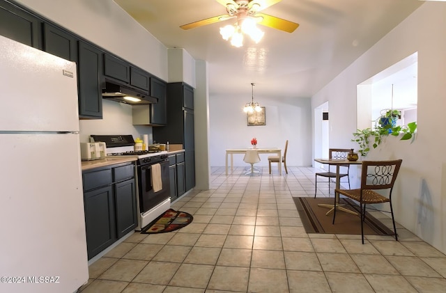 kitchen featuring ceiling fan with notable chandelier, range with gas stovetop, decorative light fixtures, white refrigerator, and light tile patterned floors