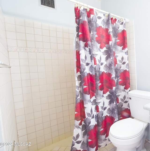 bathroom with toilet and a shower with shower curtain