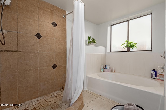 bathroom with separate shower and tub and tile patterned flooring