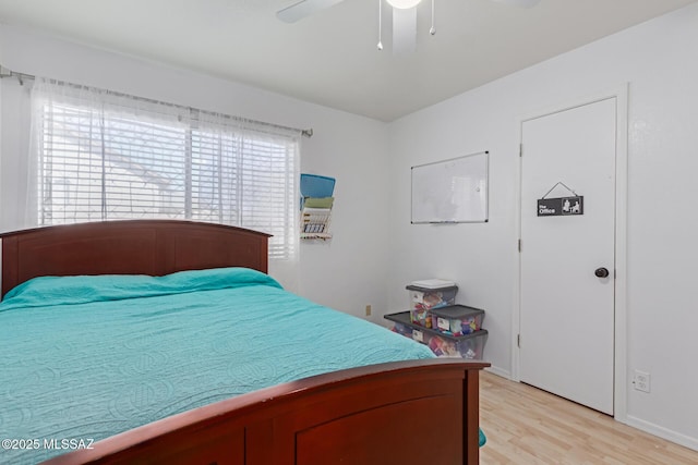 bedroom with light hardwood / wood-style floors and ceiling fan