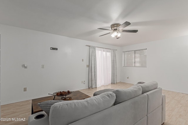 living room featuring ceiling fan and light wood-type flooring