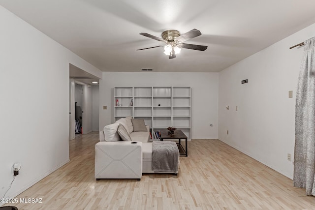 living room featuring light wood-type flooring and ceiling fan