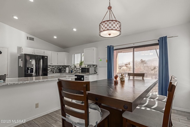 dining room featuring lofted ceiling