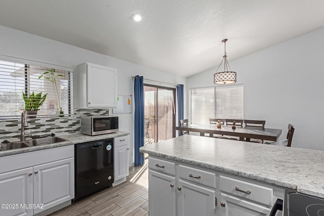 kitchen featuring sink, white cabinetry, dishwasher, and decorative light fixtures