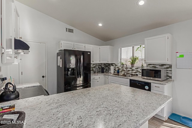 kitchen featuring sink, white cabinetry, black appliances, and vaulted ceiling