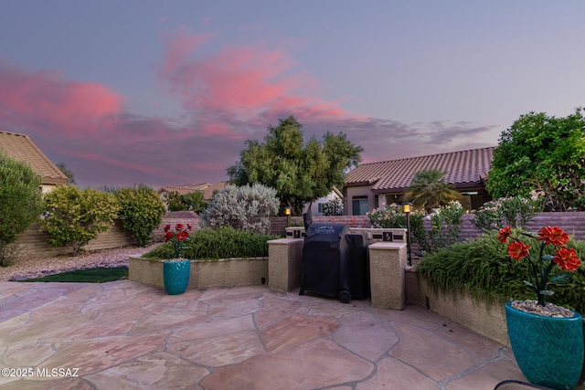 view of patio terrace at dusk