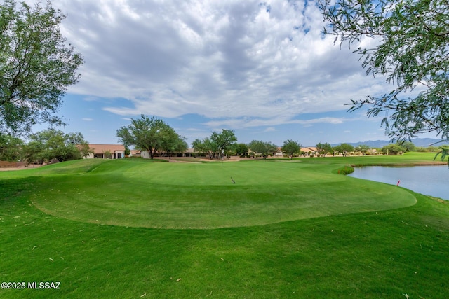 surrounding community with a lawn and a water view