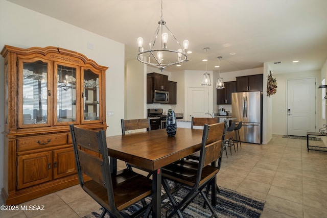 dining room featuring light tile patterned floors and a chandelier