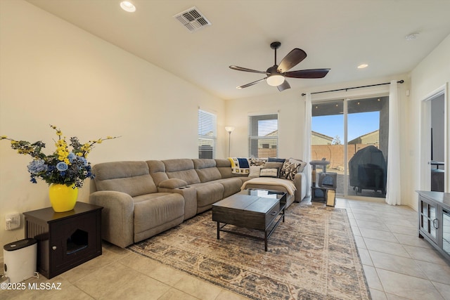 living room featuring ceiling fan and light tile patterned flooring