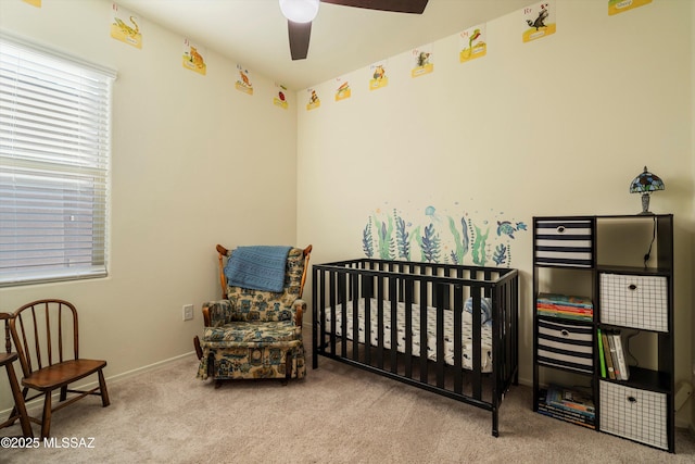 bedroom with a crib and light colored carpet