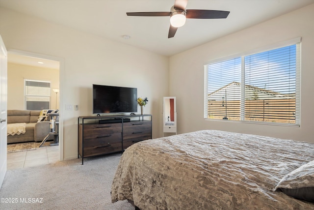 bedroom with light carpet and ceiling fan