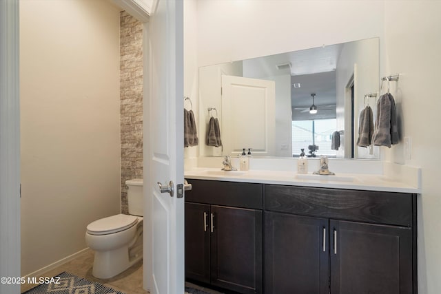 bathroom featuring vanity, tile patterned floors, and toilet