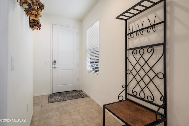 doorway to outside featuring light tile patterned flooring