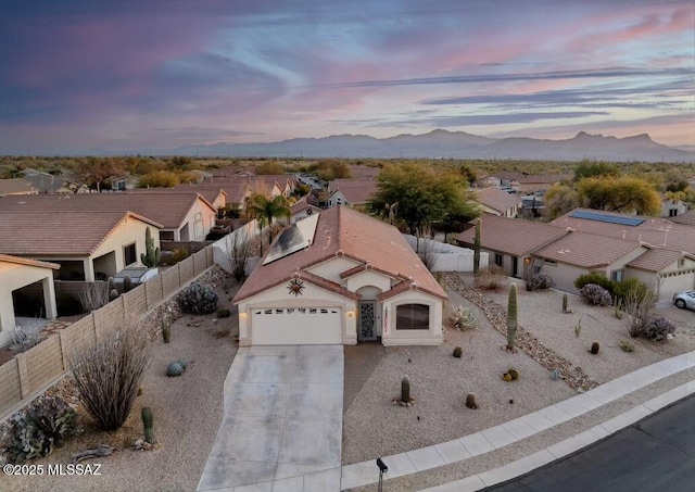 aerial view at dusk with a residential view and a mountain view