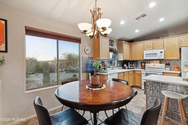 kitchen featuring white appliances, light brown cabinets, visible vents, and decorative backsplash