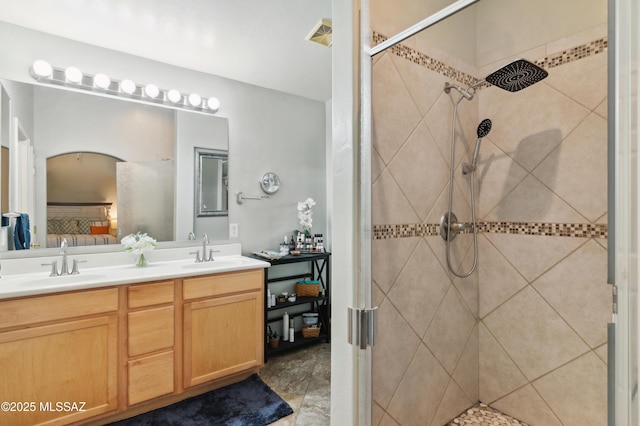 ensuite bathroom with double vanity, ensuite bath, a tile shower, and a sink