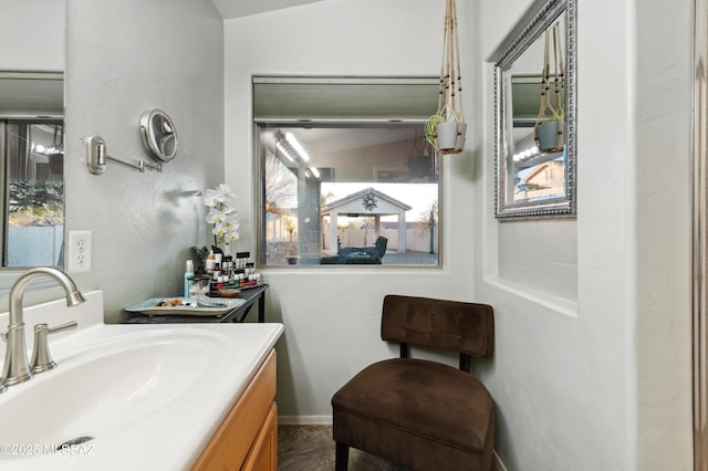 bathroom featuring vaulted ceiling and vanity