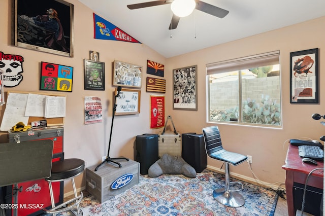 interior space with carpet floors, baseboards, ceiling fan, and lofted ceiling