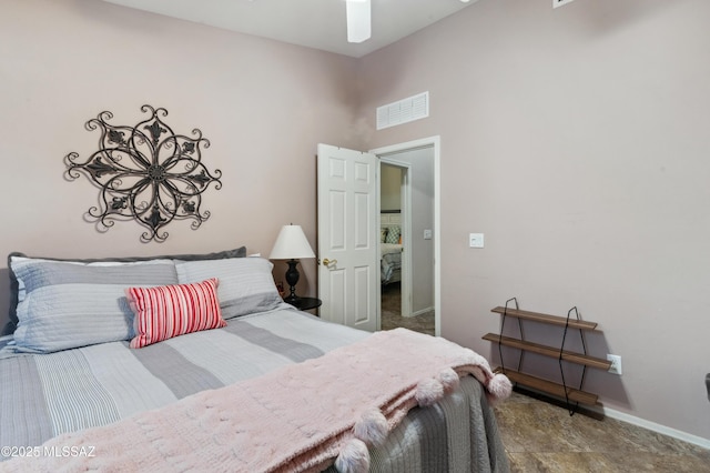 bedroom with baseboards, a high ceiling, and visible vents