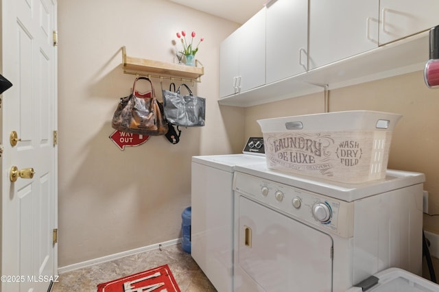 laundry room with baseboards, cabinet space, and washing machine and clothes dryer