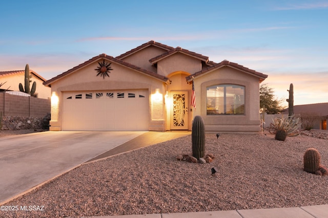 mediterranean / spanish-style home with a garage