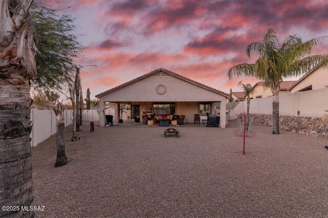 view of front of home with a garage, fence, concrete driveway, a tiled roof, and stucco siding