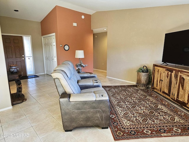 living room with high vaulted ceiling and light tile patterned floors