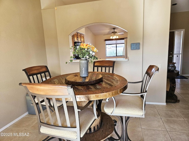 tiled dining area featuring ceiling fan