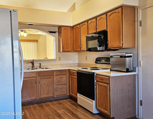 kitchen featuring sink, range with electric cooktop, fridge, and dark hardwood / wood-style flooring