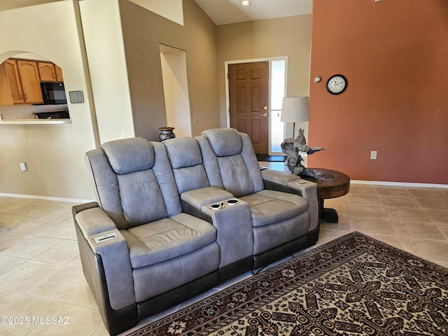 tiled living room with high vaulted ceiling