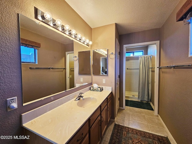 bathroom with curtained shower, a textured ceiling, tile patterned floors, and vanity